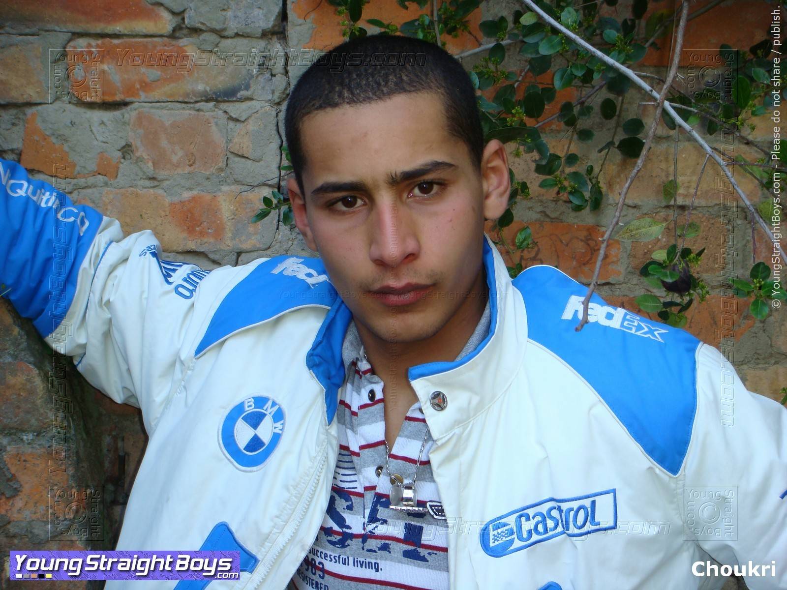 Here, Choukri (a cute 'rogue' Arab straight boy) is posing in front of an old wall