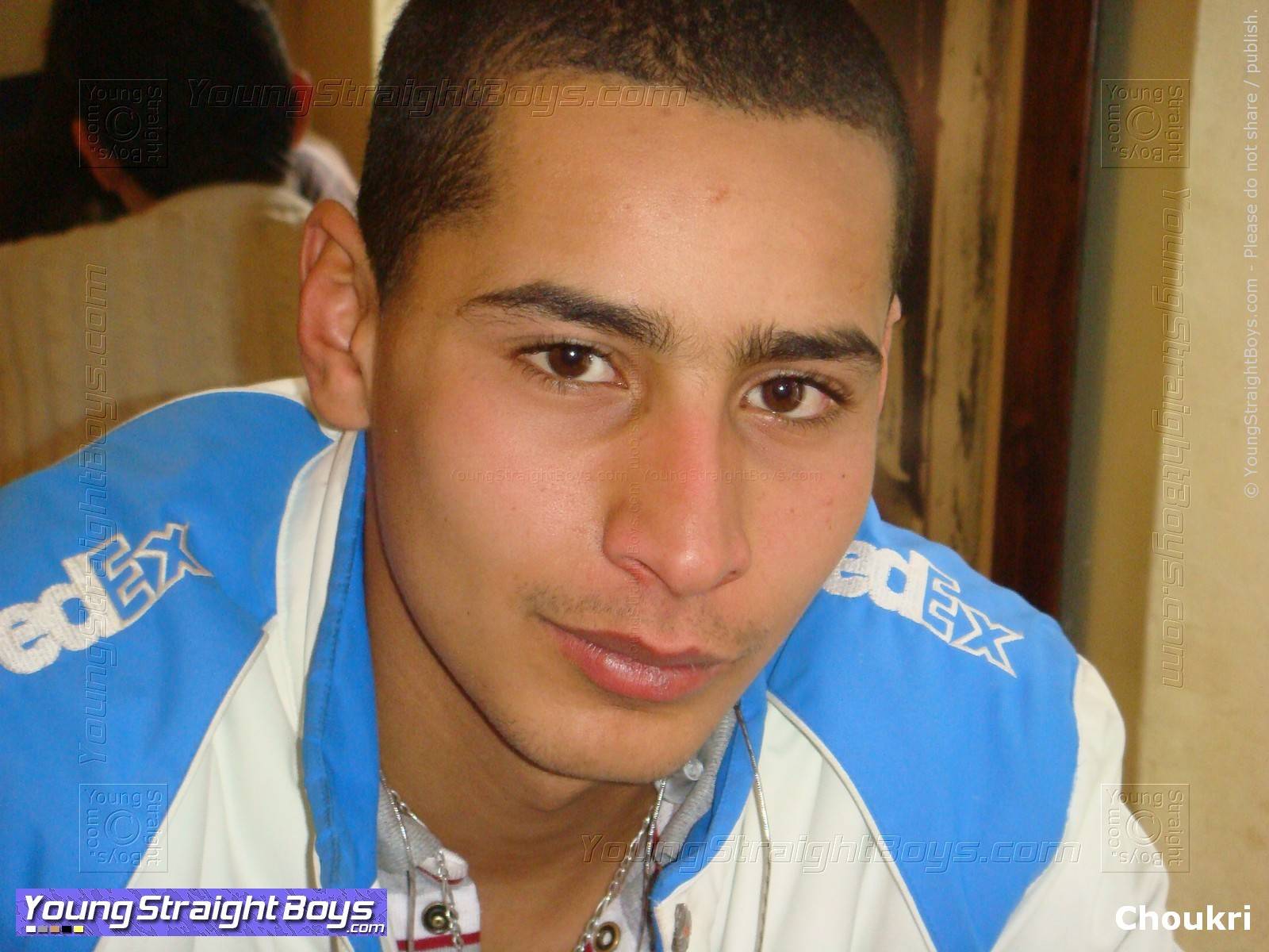 Face picture of very handsome young Arab straight twink in a café, smiling (cute face and eyes and mouth)