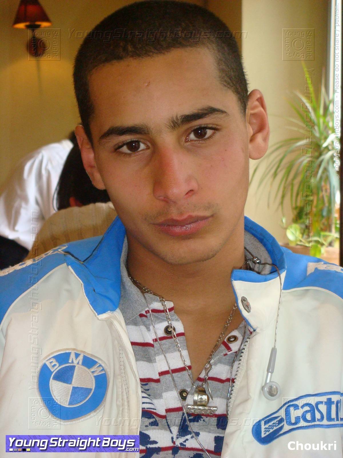 Cute 'street boy' of the Middle East in a café, with an angelic expression
